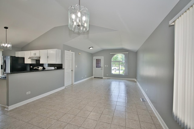 3108 141st St, Blue Island, IL 60406 - kitchen featuring freestanding refrigerator, a chandelier, vaulted ceiling, dark countertops, and light tile patterned floors