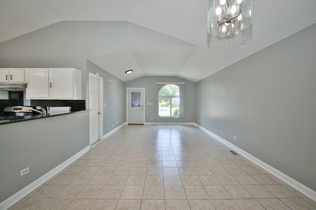 3108 141st St, Blue Island, IL 60406 - unfurnished living room featuring vaulted ceiling, a chandelier, and light tile patterned floors