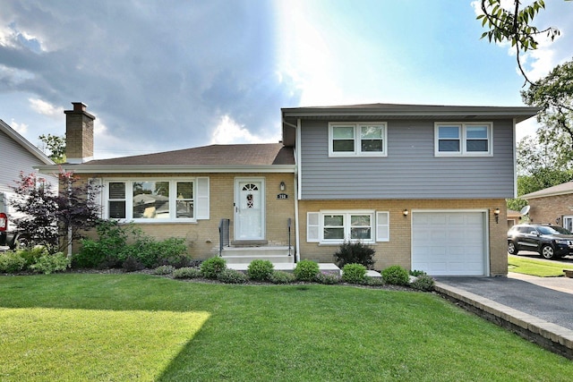 758 N Kenilworth Ave, Elmhurst, IL 60126 - tri-level home featuring a garage, brick siding, driveway, and a front lawn