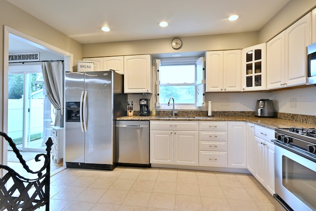 758 N Kenilworth Ave, Elmhurst, IL 60126 - kitchen with appliances with stainless steel finishes, white cabinetry, dark stone countertops, glass insert cabinets, and recessed lighting