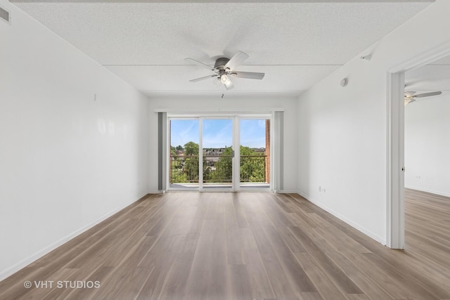 1 N Beacon Pl Unit 502, La Grange, IL 60525 - unfurnished room with ceiling fan, wood finished floors, and a textured ceiling