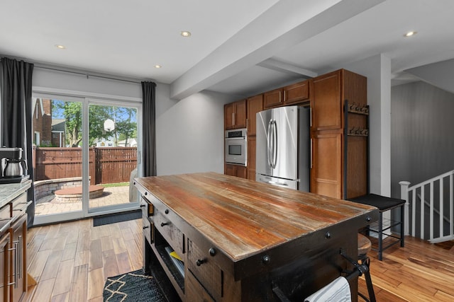 592 E 13th St, Lockport, IL 60441 - kitchen with stainless steel appliances, light wood finished floors, recessed lighting, and brown cabinetry