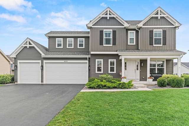 1402 Souders Ave, Elburn, IL 60119 - view of front facade with driveway, covered porch, board and batten siding, a front yard, and a shingled roof