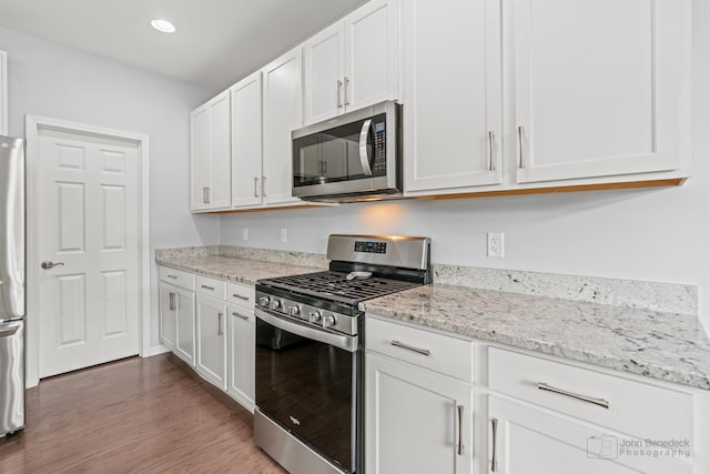 1402 Souders Ave, Elburn, IL 60119 - kitchen featuring stainless steel appliances, white cabinets, wood finished floors, light stone countertops, and recessed lighting