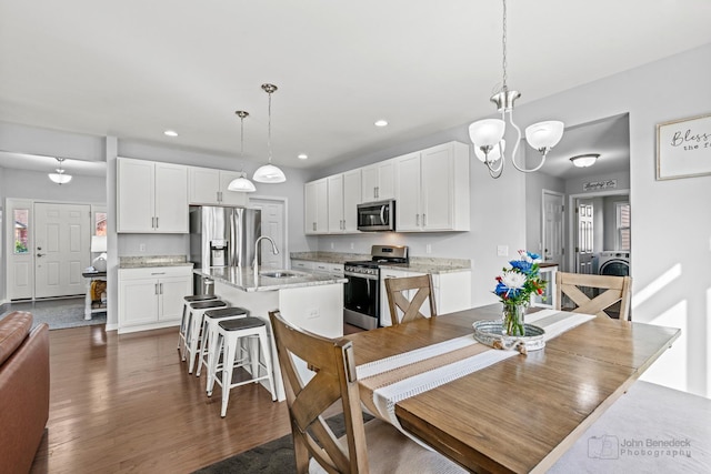 1402 Souders Ave, Elburn, IL 60119 - dining room featuring dark wood-style flooring, a chandelier, washer / clothes dryer, and recessed lighting
