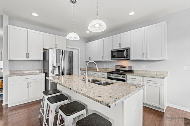 1402 Souders Ave, Elburn, IL 60119 - kitchen with stainless steel appliances, dark wood finished floors, white cabinets, recessed lighting, and a kitchen bar