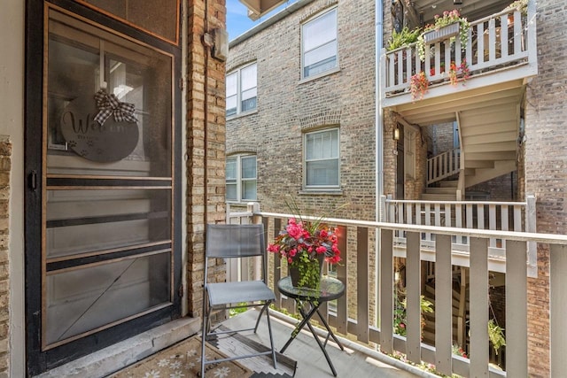 216 N Oak Park Ave Unit 2Aa, Oak Park, IL 60302 - view of exterior entry featuring a balcony and brick siding
