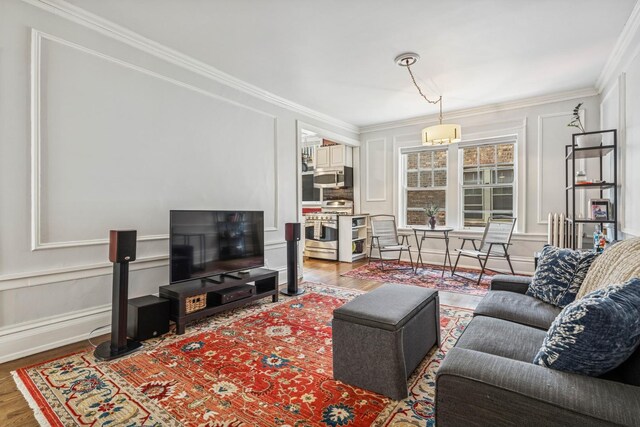 216 N Oak Park Ave Unit 2Aa, Oak Park, IL 60302 - living room featuring wood finished floors, ornamental molding, and a decorative wall