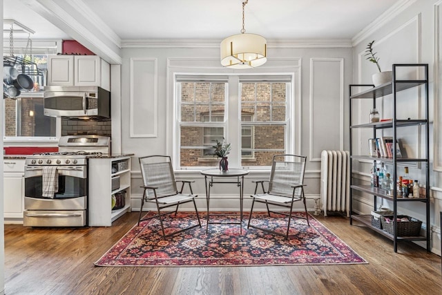 216 N Oak Park Ave Unit 2Aa, Oak Park, IL 60302 - living area with radiator, crown molding, wood finished floors, and a chandelier