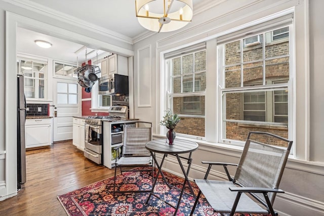 216 N Oak Park Ave Unit 2Aa, Oak Park, IL 60302 - kitchen with stainless steel appliances, a chandelier, white cabinets, crown molding, and wood finished floors