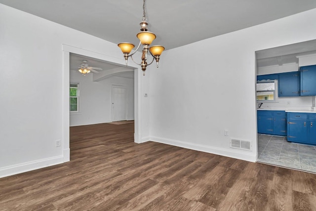 1057 W Park Front St, Joliet, IL 60436 - unfurnished dining area featuring wood finished floors, ceiling fan, and a chandelier