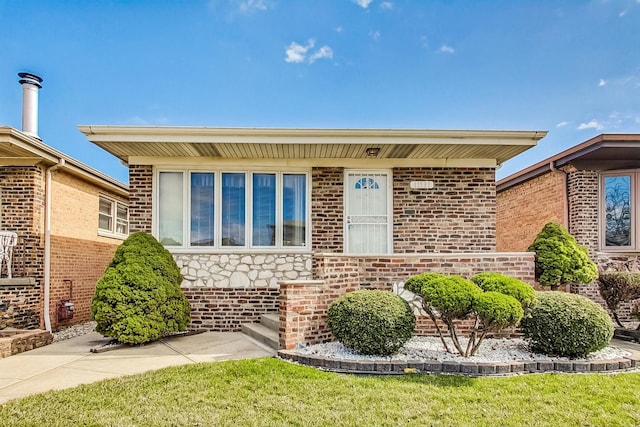 11531 S S Ave J, Chicago, IL 60617 - view of front of property with brick siding, stone siding, and a front lawn