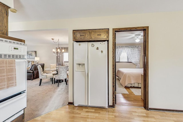 11531 S S Ave J, Chicago, IL 60617 - hallway with a chandelier and light wood-type flooring
