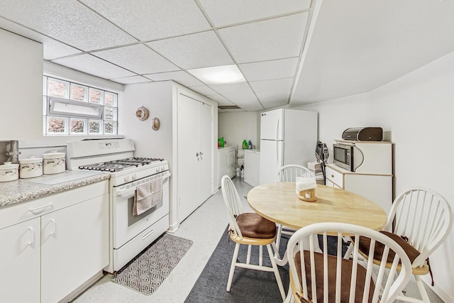 11531 S S Ave J, Chicago, IL 60617 - kitchen with white appliances, white cabinetry, light countertops, a paneled ceiling, and washer / dryer