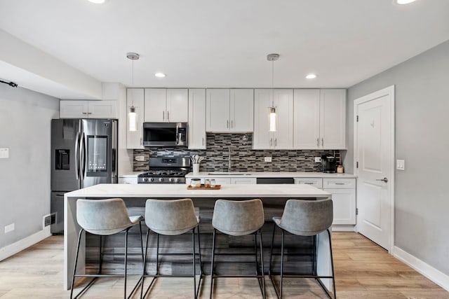 7 Cour Versaille, Palos Hills, IL 60465 - kitchen with appliances with stainless steel finishes, light countertops, decorative backsplash, a kitchen island, and recessed lighting