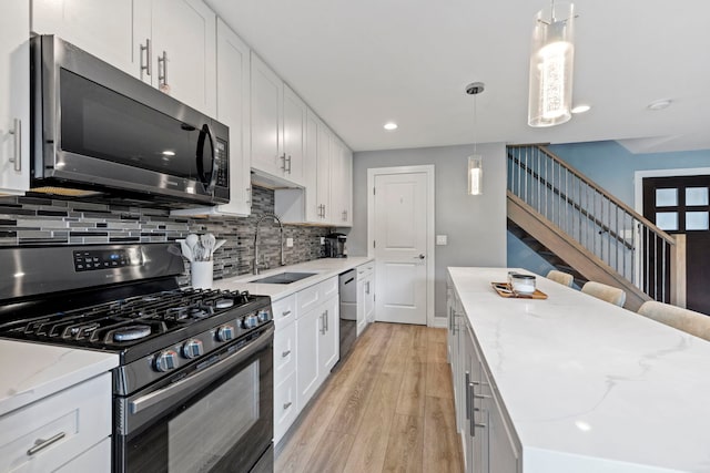 7 Cour Versaille, Palos Hills, IL 60465 - kitchen with stainless steel appliances, backsplash, light wood-type flooring, white cabinets, and light stone countertops