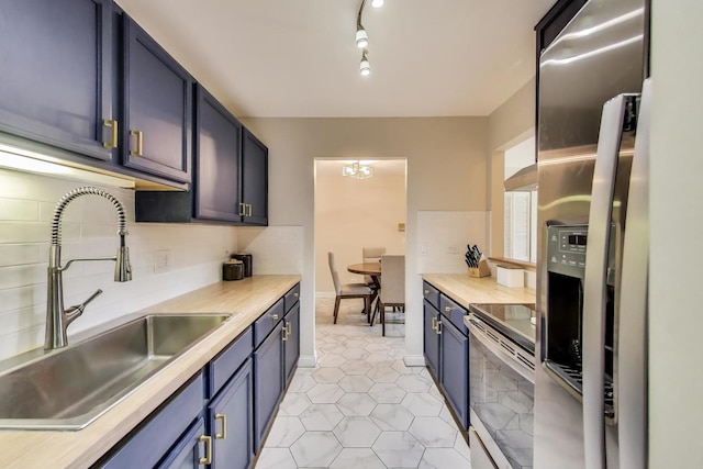 920 N Lakeside Dr Unit 1D, Vernon Hills, IL 60061 - kitchen with appliances with stainless steel finishes, light countertops, blue cabinets, and light tile patterned floors