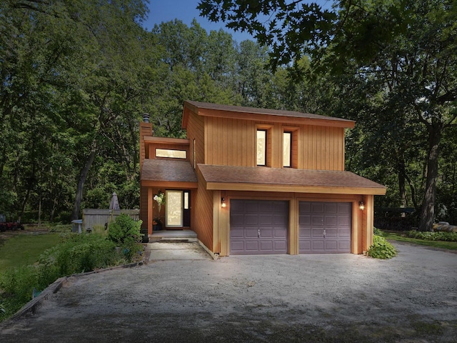 45W984 Mcdonald Rd, Hampshire, IL 60140 - view of front facade featuring a chimney, roof with shingles, and asphalt driveway