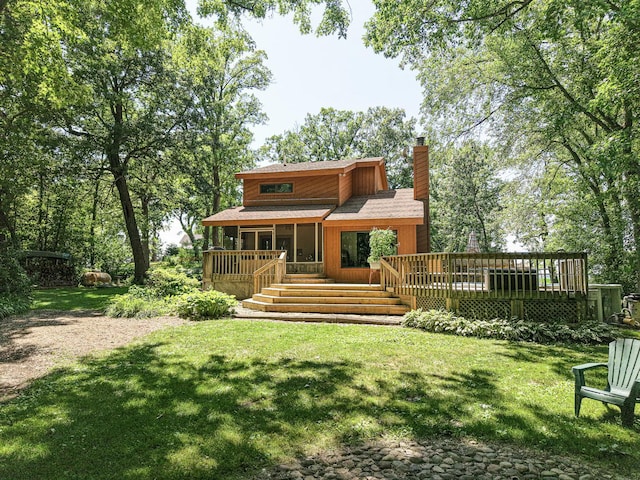 45W984 Mcdonald Rd, Hampshire, IL 60140 - rear view of house featuring a chimney, a lawn, a sunroom, and a wooden deck