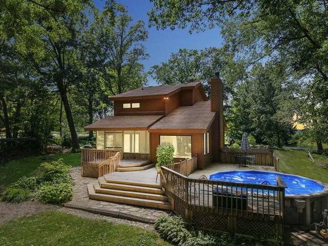 45W984 Mcdonald Rd, Hampshire, IL 60140 - back of house with roof with shingles, a chimney, a deck, and an outdoor pool