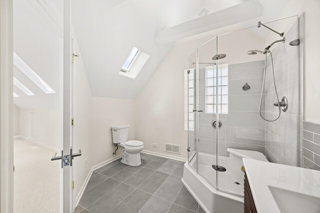 5632 S Natoma Ave, Chicago, IL 60638 - bathroom with vaulted ceiling, a skylight, vanity, enclosed tub / shower combo, and tile patterned floors