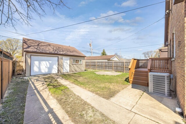 5632 S Natoma Ave, Chicago, IL 60638 - fenced backyard with concrete driveway, a detached garage, an outbuilding, and a wooden deck
