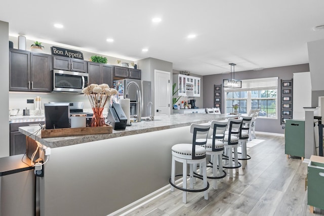 2493 Alison Ave, Pingree Grove, IL 60140 - kitchen with appliances with stainless steel finishes, light wood-style floors, dark brown cabinets, light countertops, and recessed lighting