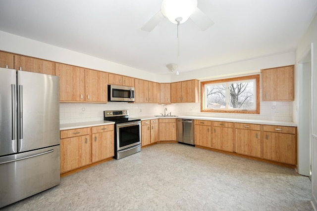 40 S Main St Unit 2D, Glen Ellyn, IL 60137 - kitchen with stainless steel appliances, light countertops, decorative backsplash, ceiling fan, and light floors