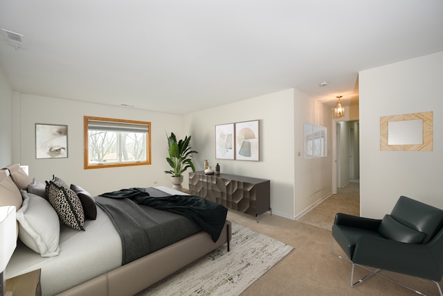 40 S Main St Unit 2D, Glen Ellyn, IL 60137 - bedroom featuring light carpet and a chandelier