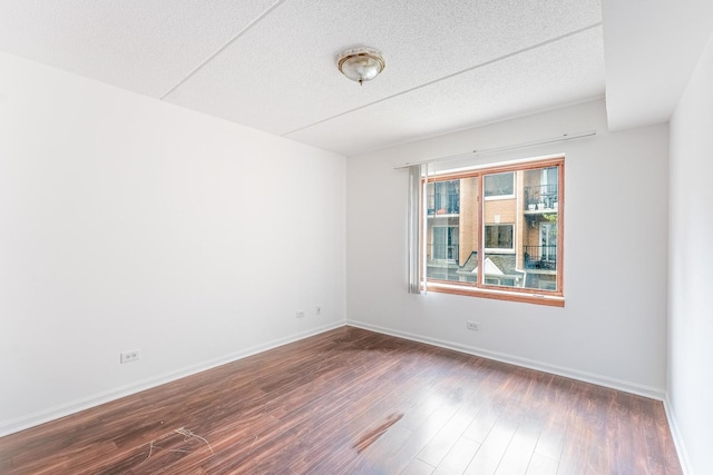 8710 W Evelyn Ln Unit 201, Chicago, IL 60656 - unfurnished room with dark wood finished floors and a textured ceiling