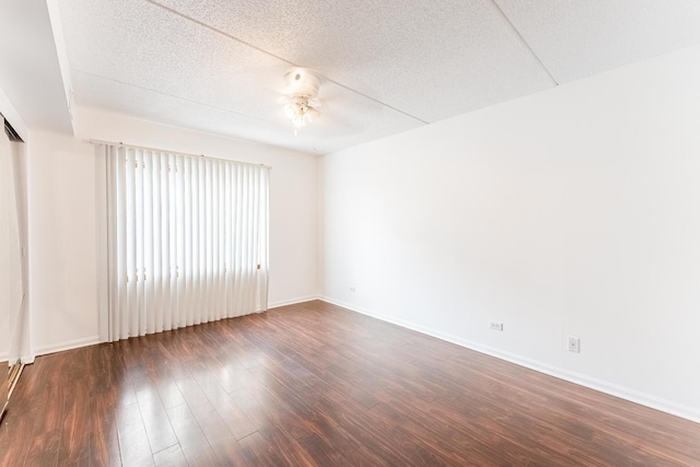 8710 W Evelyn Ln Unit 201, Chicago, IL 60656 - spare room featuring dark wood finished floors, a textured ceiling, and a ceiling fan