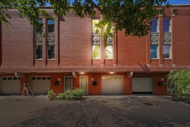 1036 Susan Collins Ln, Oak Park, IL 60302 - townhome / multi-family property with a garage, driveway, and brick siding