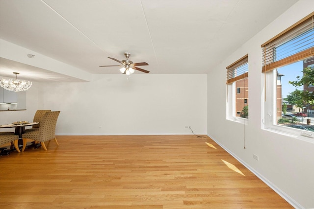 1036 Susan Collins Ln, Oak Park, IL 60302 - unfurnished living room with light wood-type flooring, a chandelier, and a ceiling fan