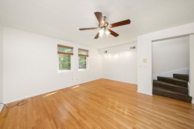 1036 Susan Collins Ln, Oak Park, IL 60302 - unfurnished room with a ceiling fan, light wood-style flooring, and stairs