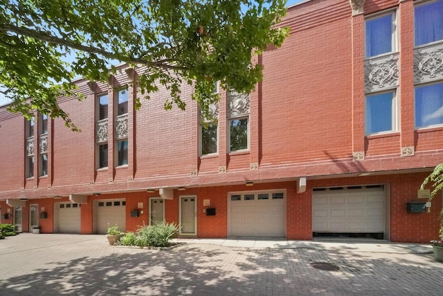 1036 Susan Collins Ln, Oak Park, IL 60302 - view of front of property featuring a garage, driveway, and brick siding