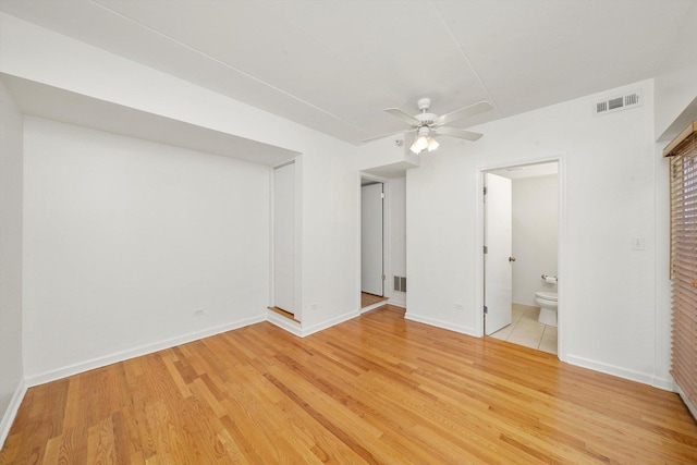 1036 Susan Collins Ln, Oak Park, IL 60302 - unfurnished bedroom with light wood-style flooring, ensuite bathroom, and ceiling fan