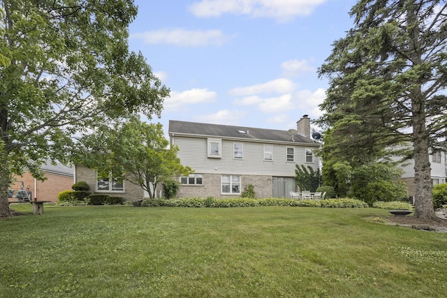 730 Kylemore Dr, Des Plaines, IL 60016 - back of property featuring a lawn and a chimney