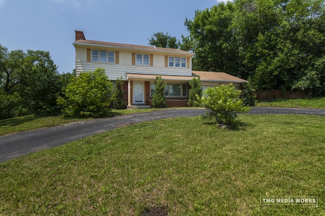 3S138 Park Blvd, Glen Ellyn, IL 60137 - view of front of property featuring driveway, a front lawn, a chimney, and brick siding