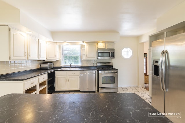 3S138 Park Blvd, Glen Ellyn, IL 60137 - kitchen featuring stainless steel appliances, healthy amount of natural light, decorative backsplash, and dark stone countertops