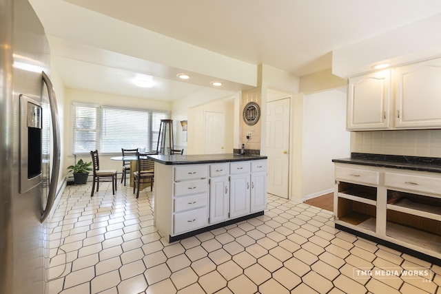 3S138 Park Blvd, Glen Ellyn, IL 60137 - kitchen featuring stainless steel refrigerator with ice dispenser, dark countertops, backsplash, white cabinetry, and open shelves