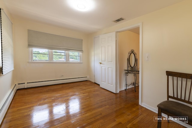 3S138 Park Blvd, Glen Ellyn, IL 60137 - unfurnished bedroom with wood finished floors and a baseboard heating unit