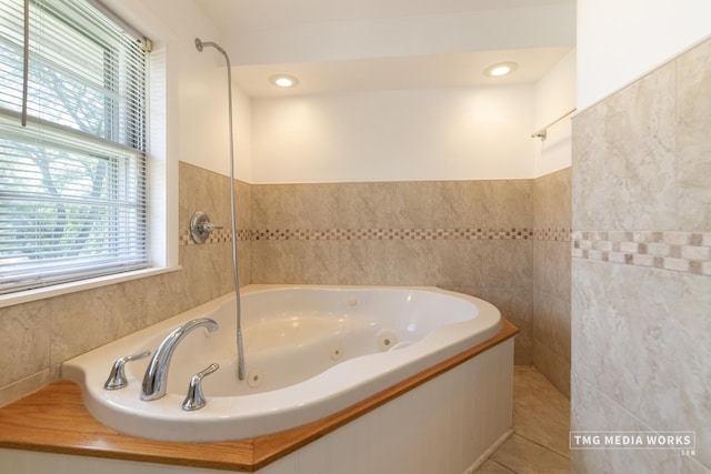 3S138 Park Blvd, Glen Ellyn, IL 60137 - bathroom featuring tile walls, a jetted tub, and tile patterned floors