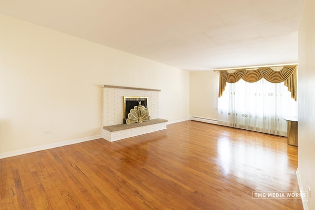3S138 Park Blvd, Glen Ellyn, IL 60137 - unfurnished living room with wood finished floors, a fireplace, and a baseboard heating unit