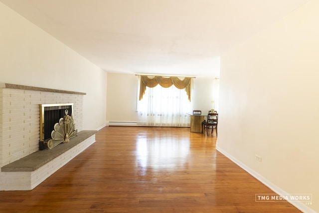 3S138 Park Blvd, Glen Ellyn, IL 60137 - unfurnished living room featuring wood finished floors, a brick fireplace, and a baseboard radiator