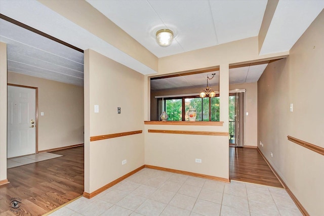 4950 134th Ct Unit 510, Crestwood, IL 60418 - unfurnished room with light wood finished floors and a chandelier