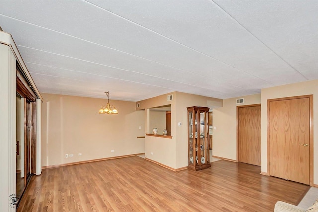 4950 134th Ct Unit 510, Crestwood, IL 60418 - unfurnished living room featuring light wood-type flooring and a chandelier