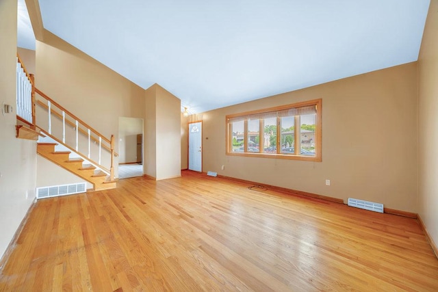 12236 S Hamlin Ave, Alsip, IL 60803 - unfurnished living room featuring stairs, wood finished floors, and lofted ceiling