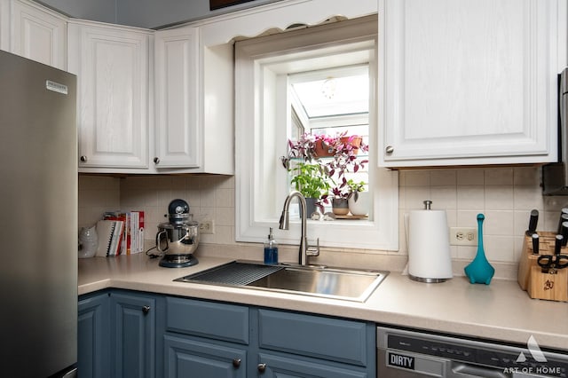 7232 W Everell Ave, Chicago, IL 60631 - kitchen featuring appliances with stainless steel finishes, blue cabinetry, white cabinets, and decorative backsplash