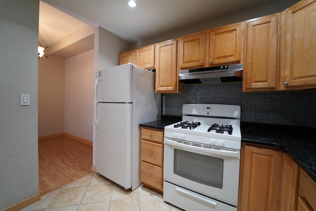 1460 Fairlane Dr Unit 119, Schaumburg, IL 60193 - kitchen with under cabinet range hood, white appliances, backsplash, light tile patterned floors, and recessed lighting