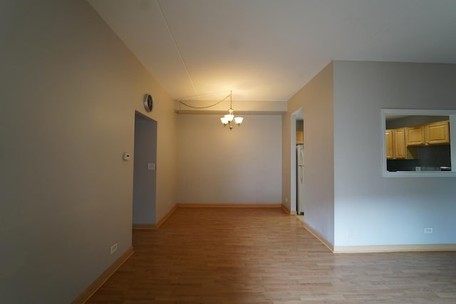 1460 Fairlane Dr Unit 119, Schaumburg, IL 60193 - empty room with a chandelier and light wood-style floors